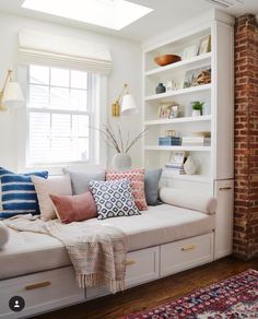 a living room filled with lots of white furniture