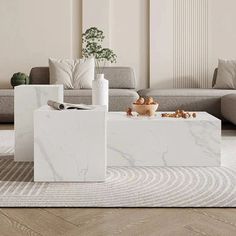 a white marble coffee table in a living room with couches and pillows on the floor