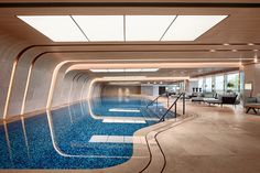 a large indoor swimming pool with blue water