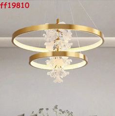 a chandelier hanging from the ceiling in a living room with white walls and flooring