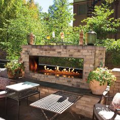 an outdoor fireplace in the middle of a patio