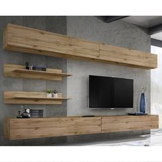 an entertainment center with wooden shelves and a flat screen tv mounted on it's wall