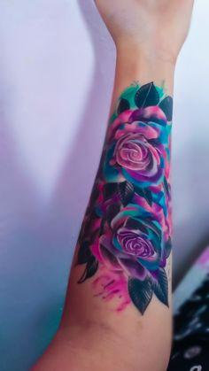 a woman's arm with flowers painted on it and the wrist is holding her hand up