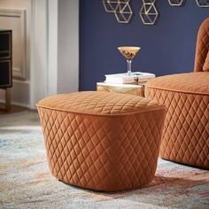 a living room with two chairs and a cocktail glass on the end table in front of it