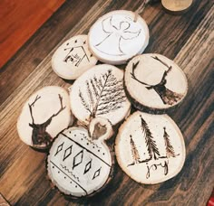 some wood slices with designs on them sitting on a table