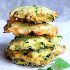 some food is stacked on top of each other with green leafy garnish