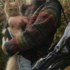 a man holding a cat in his arms