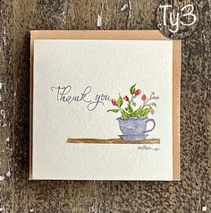 a thank card with flowers in a cup