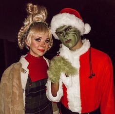 two people dressed up in costumes posing for the camera