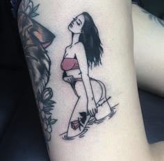 a woman with a dog tattoo on her leg