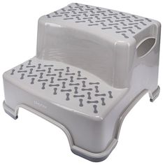 a white step stool with holes in the bottom and sides on it's legs