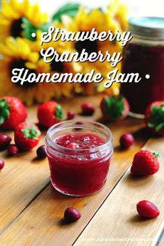 strawberry cranberry homemade jam in a jar on a wooden table with sunflowers