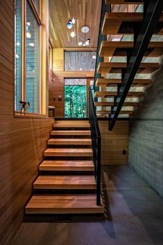 the stairs are made of wood and have metal handrails that lead up to the second floor