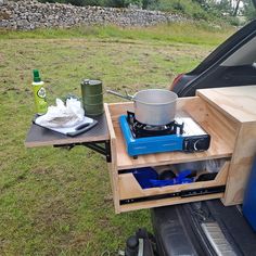 an open hatchback car trunk with a stove on it