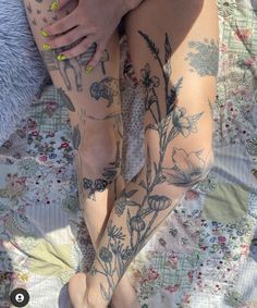 a woman's legs with tattoos on them