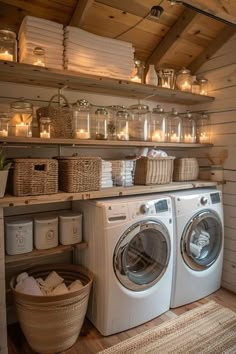 a washer and dryer in a room with shelves filled with towels, candles and baskets