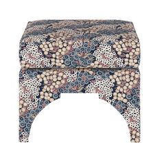 a blue and white foot stool with floral designs on the top, sitting against a white background