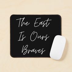 a black mouse pad with the words, the east is ourss braves written on it