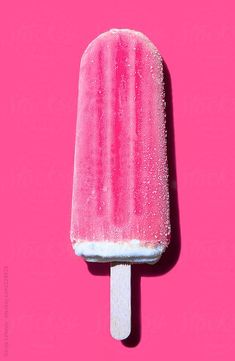 an ice cream on a pink background with sprinkles