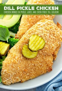 two pieces of fried chicken on a plate with broccoli and cucumbers