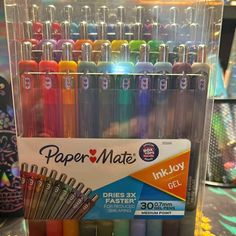 a clear container filled with lots of different colored pens