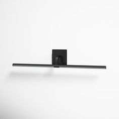 an image of a black towel rack on the wall in front of a white background