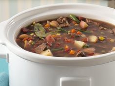 a white bowl filled with soup on top of a table