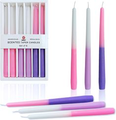 pink, purple and white candles are in a box