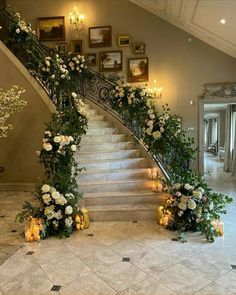 an elegant staircase decorated with flowers and candles