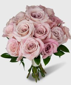 a bouquet of pink roses sitting on top of a table