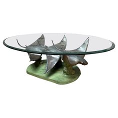 a glass table topped with metal birds