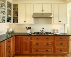 a kitchen with wooden floors and white cabinets