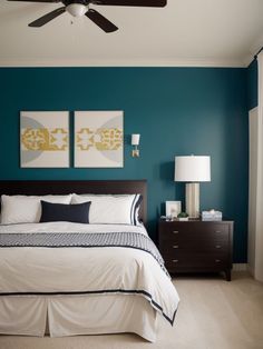 a bedroom with blue walls and white bedding