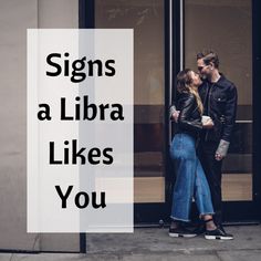 a man and woman kissing in front of a building with the words signs a libra likes you