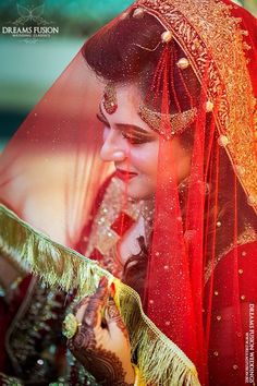 a woman in red and gold wedding outfit