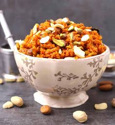 a bowl filled with rice and nuts on top of a table