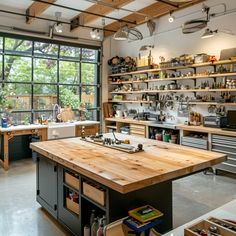 an industrial kitchen with lots of shelves and tools on the counter top in front of a large window