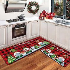 two christmas themed kitchen mats on the floor