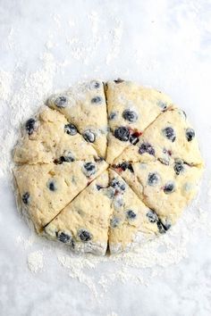 blueberry scones cut into eight pieces on a floured surface