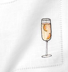 a white shirt with a glass of wine on it