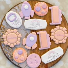 decorated cookies are arranged on a platter for a first birthday party or baby shower