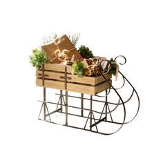 a wooden crate filled with lots of different types of christmas decorations and gifts sitting on top of a metal stand