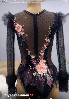 the back of a black leotard with flowers on it