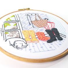 an embroidery pattern with boots and clothes on it, in front of a white background