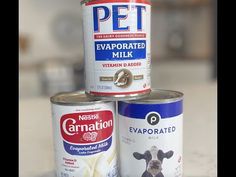 three cans of food sitting on top of a counter