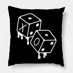 two dices on a black pillow with white paint dripping down the side and one is falling