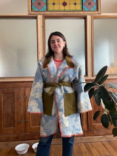 Handmade Vintage Blanket Coat 100% Wool Winter Women's. Handsewn floral blue and off-white. Belted with pockets. Fits S/M/L long wrap style blanket coat made from a vintage blanket, floral pattern. I used an olive green army surplus jacket for the pocket and collar, and did a blanket stitch with wool along the edges. The tie goes internally on the back for a beautiful flow in pattern on the back when tied.  Size small: fits over sized Size medium: fits slightly over sized Size large: fits true to size One of a kind, there's no other one like this! From the brain and heart of Erin Wakeland Diy Blanket Jacket, Blanket Jacket Diy, Blanket Coat Pattern, Army Surplus Jacket, Wool Blanket Coat, Long Quilted Coat, Blanket Jacket, Fall Blanket, Floral Blanket