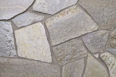 a stone wall that is made out of various types of stones and has been used as a background