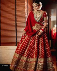 a woman in a red and gold bridal gown