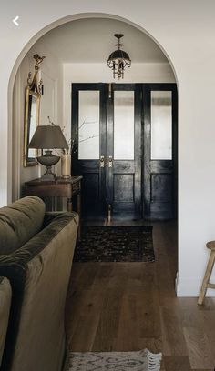 a living room filled with furniture and a black door